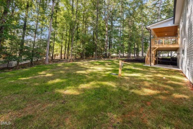 Enjoy one-level living in this beautifully crafted custom ranch on River Golf and Country Club at Lake Royale in North Carolina - for sale on GolfHomes.com, golf home, golf lot