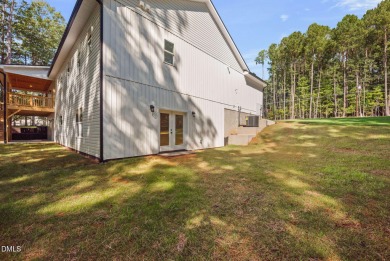 Enjoy one-level living in this beautifully crafted custom ranch on River Golf and Country Club at Lake Royale in North Carolina - for sale on GolfHomes.com, golf home, golf lot