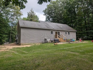 Nestled in a serene neighborhood within the Michaywe Association on Michaywe Pines Course in Michigan - for sale on GolfHomes.com, golf home, golf lot