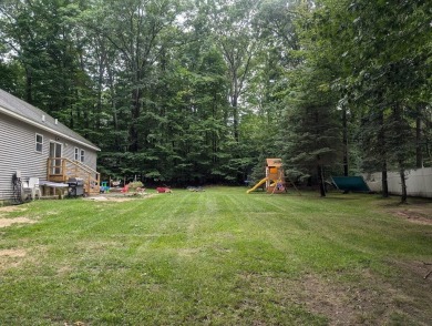 Nestled in a serene neighborhood within the Michaywe Association on Michaywe Pines Course in Michigan - for sale on GolfHomes.com, golf home, golf lot