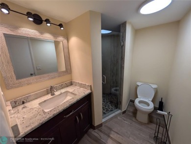 This beautifully renovated 3-bedroom, 2-bathroom corner unit at on Woodmont Country Club in Florida - for sale on GolfHomes.com, golf home, golf lot