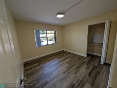 This beautifully renovated 3-bedroom, 2-bathroom corner unit at on Woodmont Country Club in Florida - for sale on GolfHomes.com, golf home, golf lot