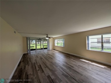This beautifully renovated 3-bedroom, 2-bathroom corner unit at on Woodmont Country Club in Florida - for sale on GolfHomes.com, golf home, golf lot