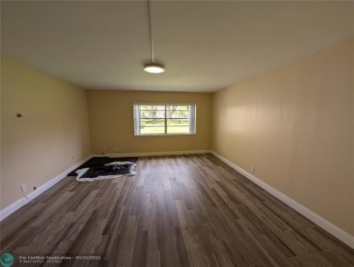 This beautifully renovated 3-bedroom, 2-bathroom corner unit at on Woodmont Country Club in Florida - for sale on GolfHomes.com, golf home, golf lot