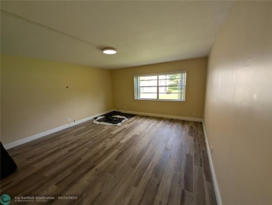 This beautifully renovated 3-bedroom, 2-bathroom corner unit at on Woodmont Country Club in Florida - for sale on GolfHomes.com, golf home, golf lot