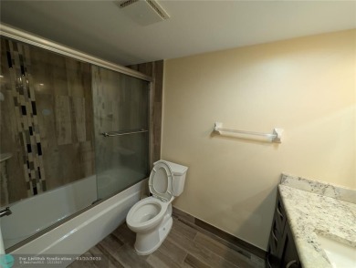 This beautifully renovated 3-bedroom, 2-bathroom corner unit at on Woodmont Country Club in Florida - for sale on GolfHomes.com, golf home, golf lot