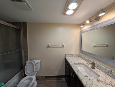 This beautifully renovated 3-bedroom, 2-bathroom corner unit at on Woodmont Country Club in Florida - for sale on GolfHomes.com, golf home, golf lot