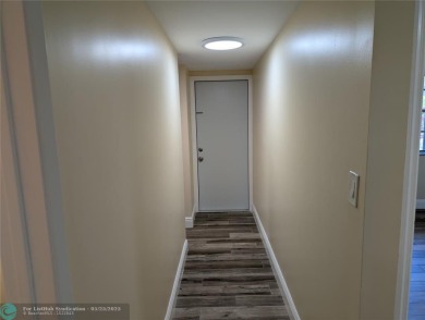 This beautifully renovated 3-bedroom, 2-bathroom corner unit at on Woodmont Country Club in Florida - for sale on GolfHomes.com, golf home, golf lot