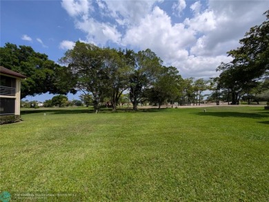 This beautifully renovated 3-bedroom, 2-bathroom corner unit at on Woodmont Country Club in Florida - for sale on GolfHomes.com, golf home, golf lot