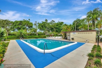 This beautifully renovated 3-bedroom, 2-bathroom corner unit at on Woodmont Country Club in Florida - for sale on GolfHomes.com, golf home, golf lot