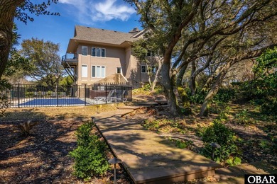 Bold in design and unmistakable in presence, this custom-built on The Currituck Golf Club in North Carolina - for sale on GolfHomes.com, golf home, golf lot