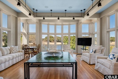 Bold in design and unmistakable in presence, this custom-built on The Currituck Golf Club in North Carolina - for sale on GolfHomes.com, golf home, golf lot