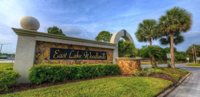 Welcome to this inviting 4-bedroom, 2-bathroom home located in on East Lake Woodlands Country Club in Florida - for sale on GolfHomes.com, golf home, golf lot