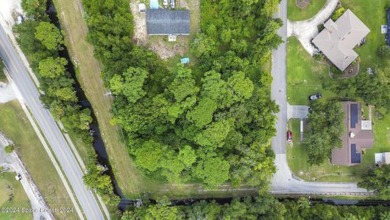 Nestled in the heart of New Smyrna Beach, this treed buildable on New Smyrna Beach Golf Course in Florida - for sale on GolfHomes.com, golf home, golf lot