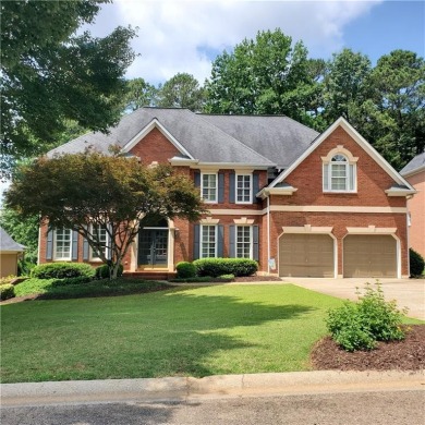 Wonderful brick and frame home positioned between two on Towne Lake Hills Golf Club in Georgia - for sale on GolfHomes.com, golf home, golf lot