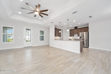 Enjoy peaceful water and wooded views in this beautifully on Venetian Bay Golf Course in Florida - for sale on GolfHomes.com, golf home, golf lot