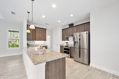 Enjoy peaceful water and wooded views in this beautifully on Venetian Bay Golf Course in Florida - for sale on GolfHomes.com, golf home, golf lot