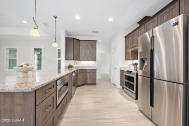 Enjoy peaceful water and wooded views in this beautifully on Venetian Bay Golf Course in Florida - for sale on GolfHomes.com, golf home, golf lot