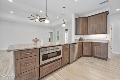 Enjoy peaceful water and wooded views in this beautifully on Venetian Bay Golf Course in Florida - for sale on GolfHomes.com, golf home, golf lot
