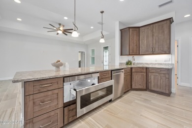 Enjoy peaceful water and wooded views in this beautifully on Venetian Bay Golf Course in Florida - for sale on GolfHomes.com, golf home, golf lot