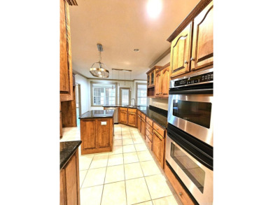 Nice all-brick home with vinyl accents located on Magellan Golf on Magellan Golf Course in Arkansas - for sale on GolfHomes.com, golf home, golf lot