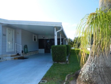 1,801 sq. ft. 2 bed/2 bath 1986 Redman 26x52 features a lanai on on Grasslands Golf and Country Club in Florida - for sale on GolfHomes.com, golf home, golf lot