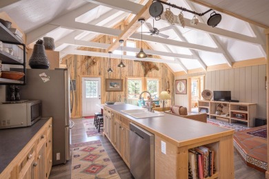 Settle into this charming mountain home overlooking the 11th on Angel Fire Resort Country Club in New Mexico - for sale on GolfHomes.com, golf home, golf lot