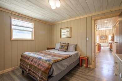 Settle into this charming mountain home overlooking the 11th on Angel Fire Resort Country Club in New Mexico - for sale on GolfHomes.com, golf home, golf lot
