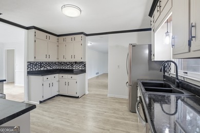 Welcome home to 560 Clubhouse Drive, ideally situated on a quiet on Honey Creek Country Club in Georgia - for sale on GolfHomes.com, golf home, golf lot