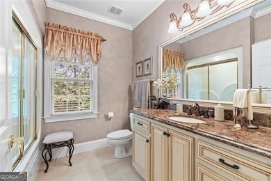 This exquisite four-sided blush brick estate is the epitome of on Royal Lakes Golf and Country Club in Georgia - for sale on GolfHomes.com, golf home, golf lot