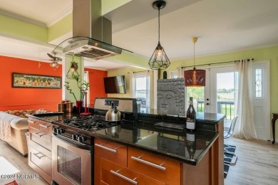 Experience waterfront living at its finest at 5802 E Yacht Drive on Founders Club At St. James Plantation in North Carolina - for sale on GolfHomes.com, golf home, golf lot