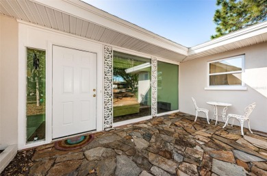 This Mid-Century Modern ranch home is centrally located just on The Dunedin Country Club in Florida - for sale on GolfHomes.com, golf home, golf lot
