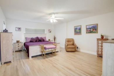 WELCOME TO THIS SPACIOUS, ATTRACTIVE CORNER, TOP FLOOR  CONDO on Poinciana Golf Club in Florida - for sale on GolfHomes.com, golf home, golf lot