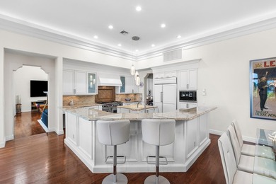 This exceptional lakeside estate blends sophistication, comfort on Bocaire Country Club in Florida - for sale on GolfHomes.com, golf home, golf lot