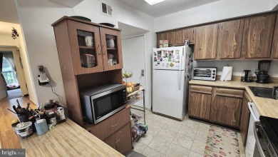For your downsizing pleasure---a perfect corner unit away from on Leisure World Golf Club in Maryland - for sale on GolfHomes.com, golf home, golf lot