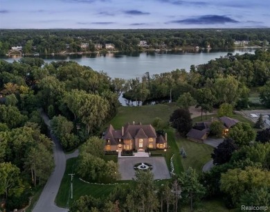 Set on over two acres along the coveted shores of all-sports on Orchard Lake Country Club in Michigan - for sale on GolfHomes.com, golf home, golf lot