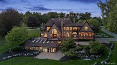 Set on over two acres along the coveted shores of all-sports on Orchard Lake Country Club in Michigan - for sale on GolfHomes.com, golf home, golf lot