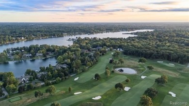 Set on over two acres along the coveted shores of all-sports on Orchard Lake Country Club in Michigan - for sale on GolfHomes.com, golf home, golf lot