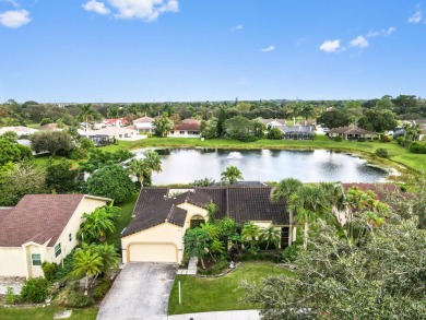 This stunning lakefront home in the highly desirable Elysium on Village Golf Club in Florida - for sale on GolfHomes.com, golf home, golf lot