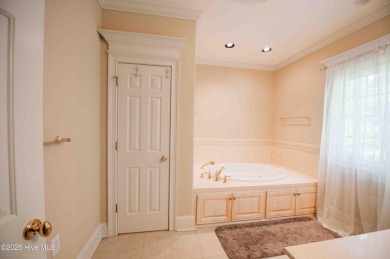 This exquisite brick home is tucked away on a cul-de-sac within on Pinewild Country Club of Pinehurst in North Carolina - for sale on GolfHomes.com, golf home, golf lot