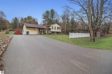 Discover comfort and convenience in this well-maintained on Bear Lake Highlands Golf Course in Michigan - for sale on GolfHomes.com, golf home, golf lot