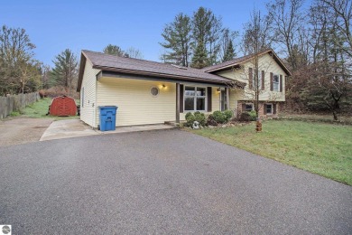Discover comfort and convenience in this well-maintained on Bear Lake Highlands Golf Course in Michigan - for sale on GolfHomes.com, golf home, golf lot