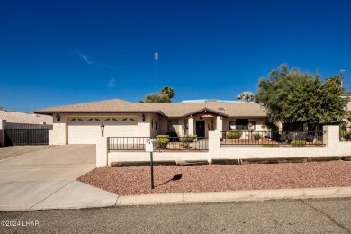 It is a quick golf cart trip down the street to the beautiful on London Bridge Golf Course in Arizona - for sale on GolfHomes.com, golf home, golf lot