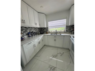 A beautifully remodeled two-bedroom, two-bathroom apartment on Sunrise Lakes Phase IV Golf Course in Florida - for sale on GolfHomes.com, golf home, golf lot