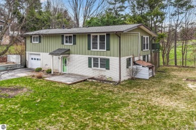 Located just within the city limits, this home offers character on Traverse City Golf and Country Club in Michigan - for sale on GolfHomes.com, golf home, golf lot