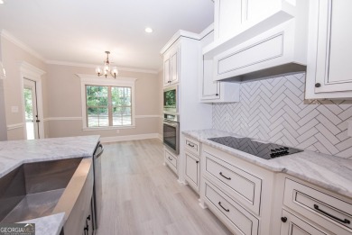 Nestled on 2.22 acres, this exquisite new construction two-story on Perry Country Club in Georgia - for sale on GolfHomes.com, golf home, golf lot
