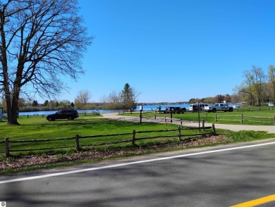 Beautiful lot at all sports private Lake Isabella with road on The Pines Golf Course at Lake Isabella in Michigan - for sale on GolfHomes.com, golf home, golf lot