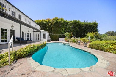 Tucked behind lush landscaping on one of the most coveted and on Los Angeles Country Club in California - for sale on GolfHomes.com, golf home, golf lot