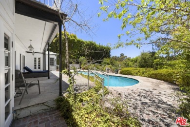Tucked behind lush landscaping on one of the most coveted and on Los Angeles Country Club in California - for sale on GolfHomes.com, golf home, golf lot