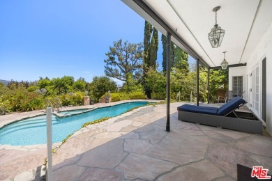 Tucked behind lush landscaping on one of the most coveted and on Los Angeles Country Club in California - for sale on GolfHomes.com, golf home, golf lot
